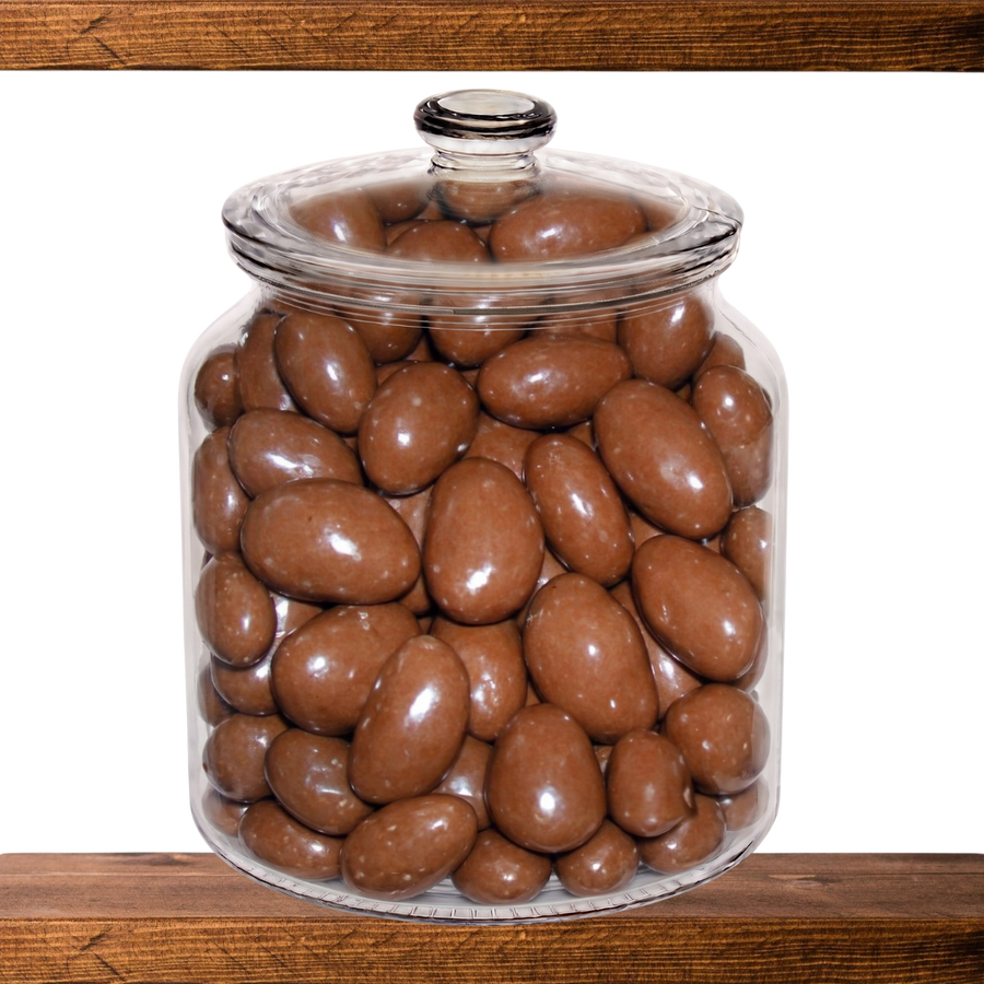Chocolate Brazil Nuts in a glass sweet jar on the shelf at Mr Swainstons